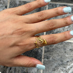 Open fishbone ring with blue manicure