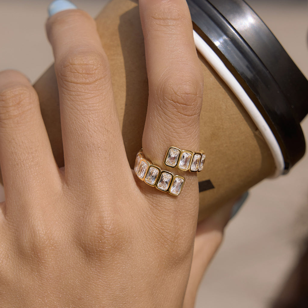 Gold-tone open ring shown on a hand