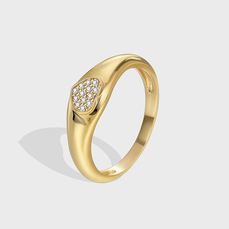 isolated gold plated heart signet ring with clear zirconia