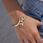 Curved three-stone cuff worn beside denim