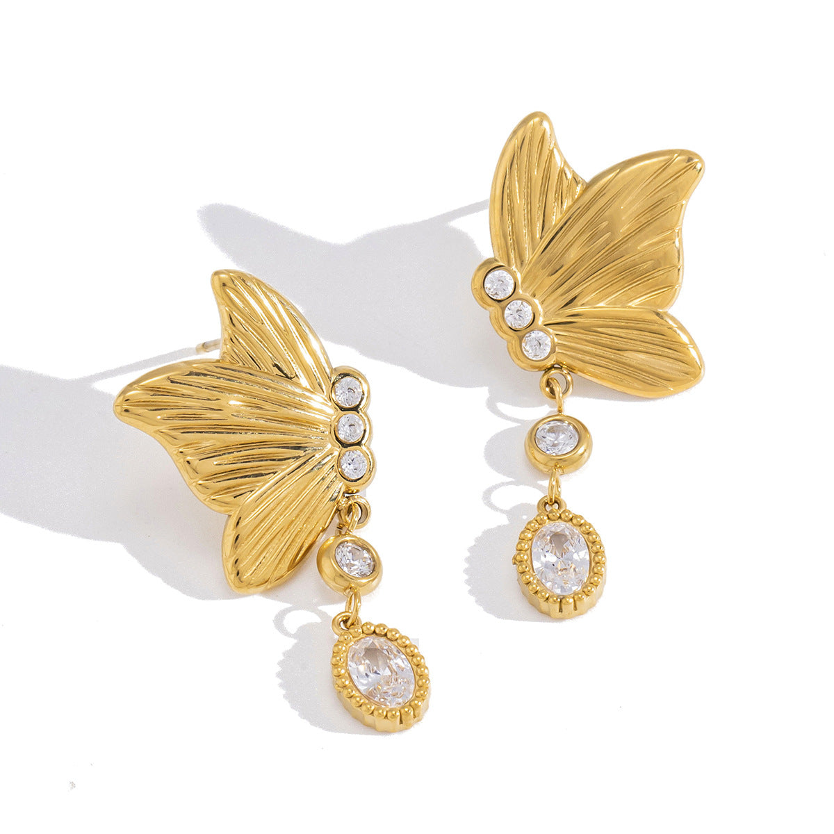 gold plated butterfly clear-stone drop earrings isolated on white