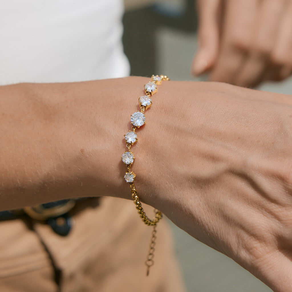 Graduated round-stone bracelet worn alone