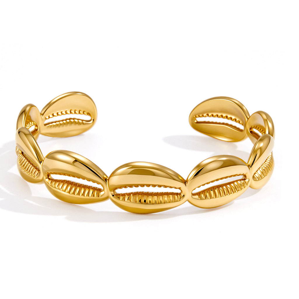 Open stainless steel cuff with repeating cowrie-shell shapes