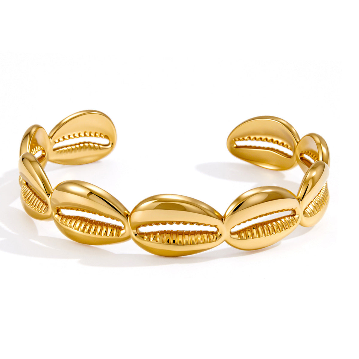 Open stainless steel cuff with repeating cowrie-shell shapes