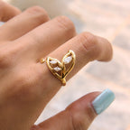Open leaf ring with clear stones shown on hand