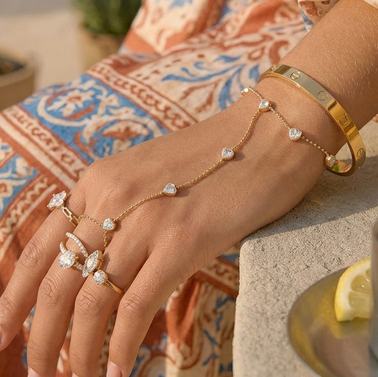 Clear stone hand chain styled with decorative rings