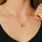 model wearing a small pink quartz and flower pendant necklace