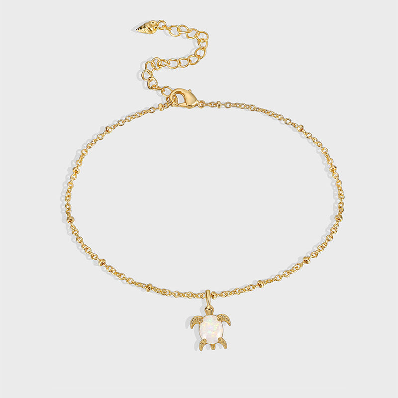 gold plated sea turtle iridescent charm anklet on gray