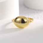 front view of the polished oval dome ring on a white block