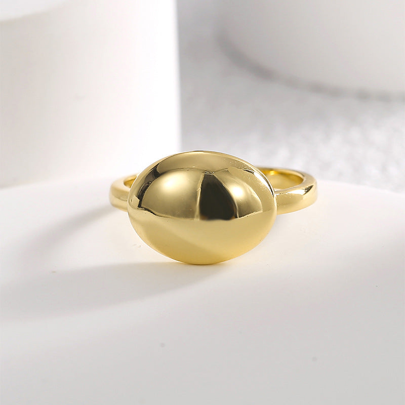 front view of the polished oval dome ring on a white block
