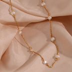 Freshwater pearl station necklace draped over pale fabric