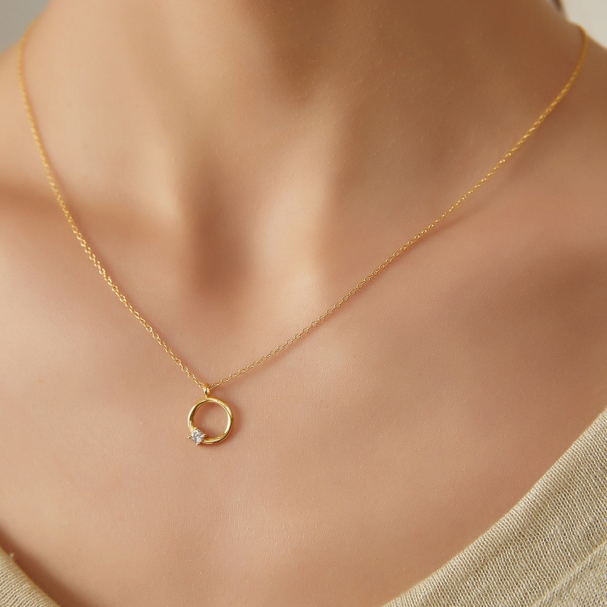 model wearing a petite gold plated open circle necklace