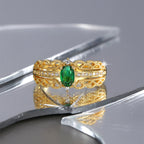 front studio view of the green and clear stone ornate ring