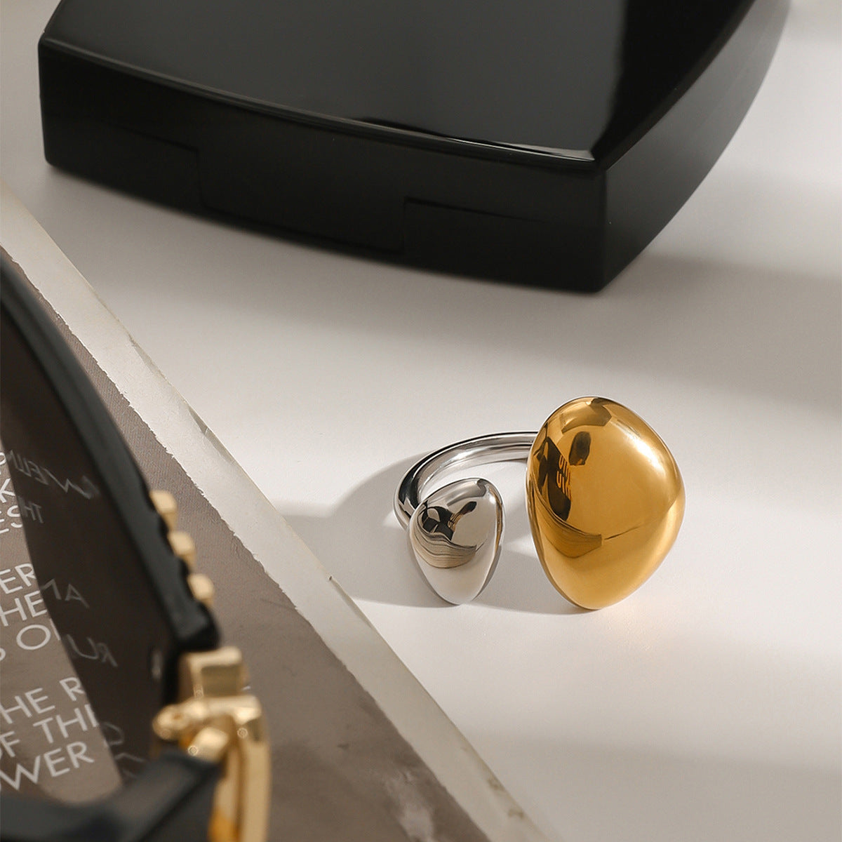 Angled view of the gold and silver-colored oval ring