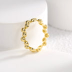 upright gold plated pebble ring showing linked construction