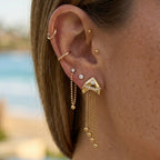 Fish tassel earring worn in an ear arrangement