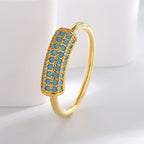 angled geometric ring showing two rows of blue color inlays