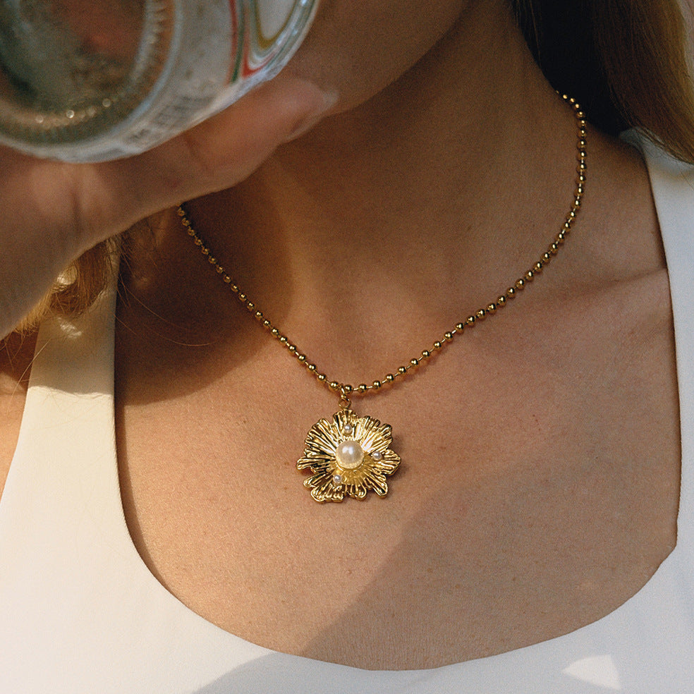 Gold-Tone Floral Stainless Steel Pendant Necklace Collection shown on model