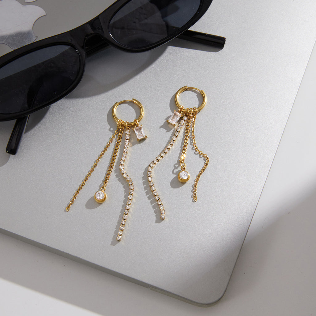 Stone and chain strands arranged beside sunglasses