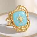 gold plated turtle open ring with turquoise-blue enamel panel