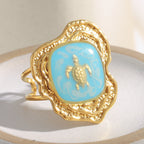 gold plated turtle open ring with turquoise-blue enamel panel