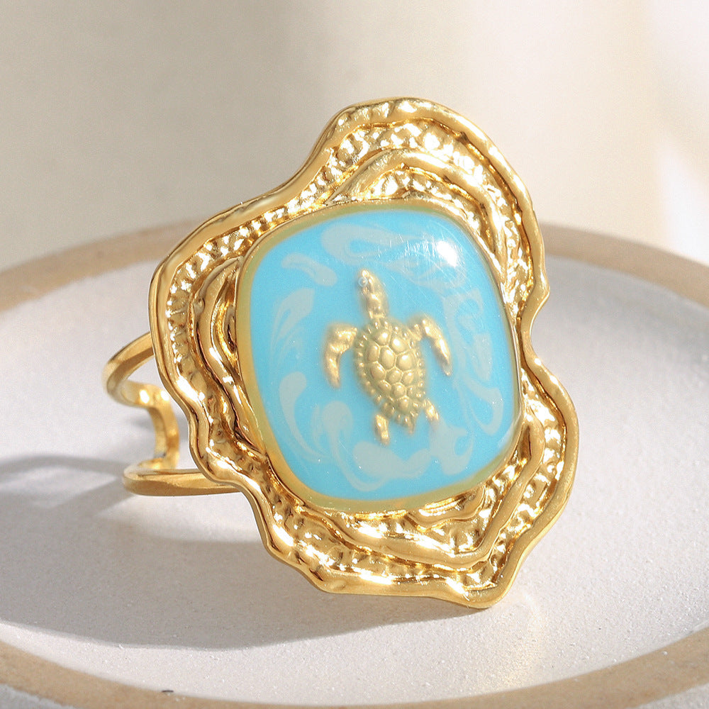 gold plated turtle open ring with turquoise-blue enamel panel