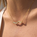 gold plated clear-stone wave necklace worn on model
