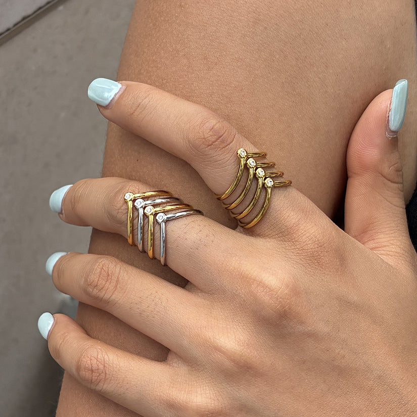 Gold and two-tone chevron rings worn on two fingers