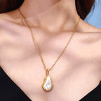 Irregular white pendant necklace worn with a black top
