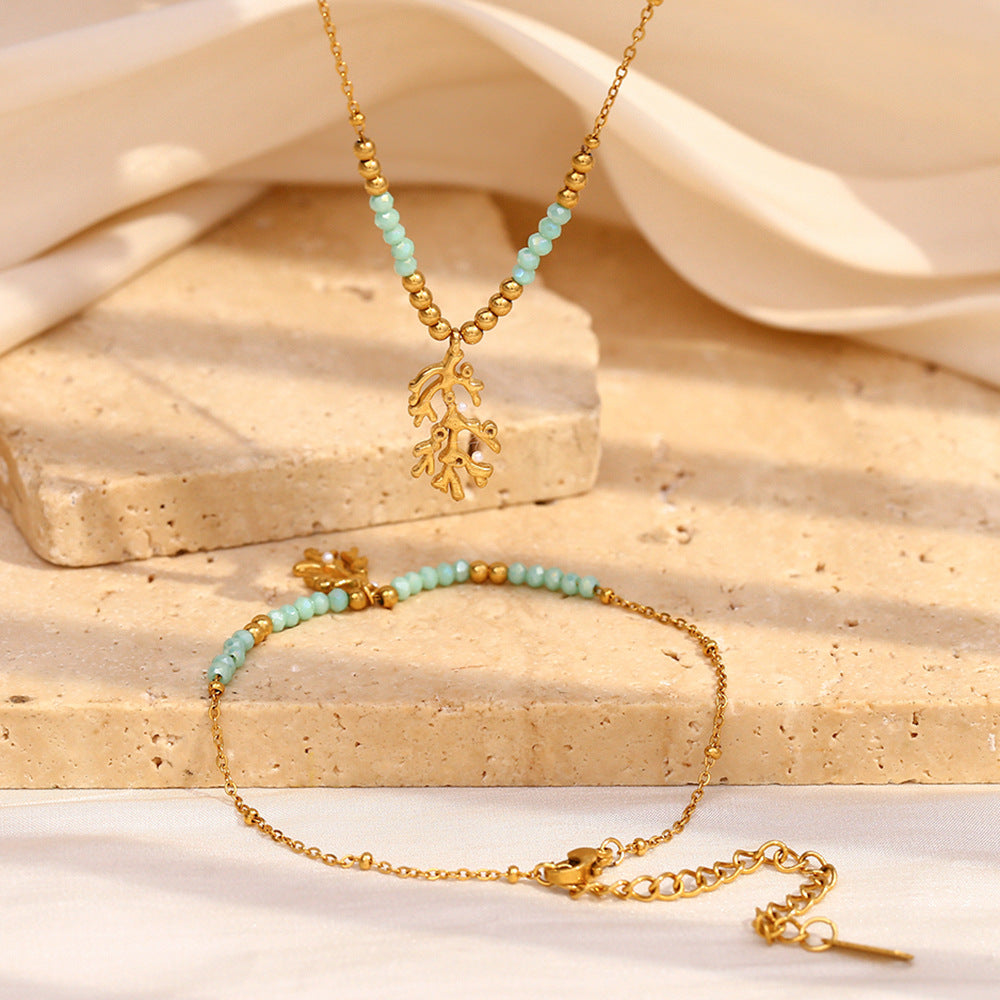 Gold plated branch charm necklace and bracelet display