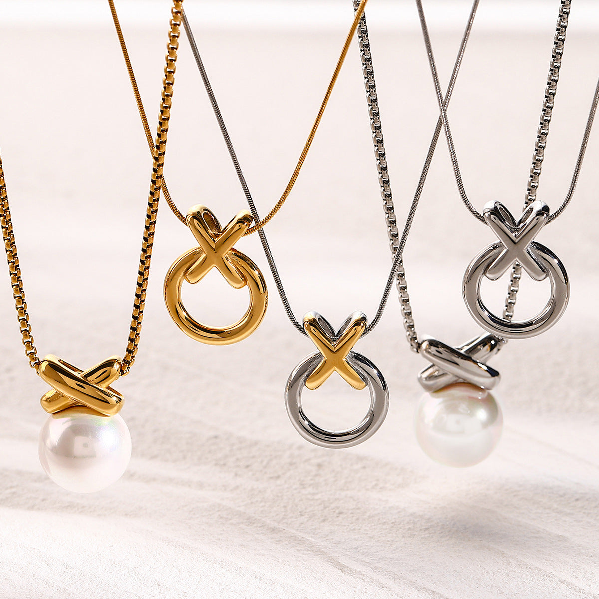 XO circle pendant necklaces shown with pearl-drop reference designs