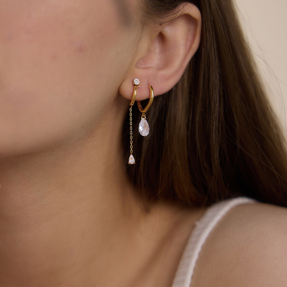 Fine chain teardrop hoop worn beside a separate short drop hoop
