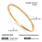 Gold tone bangle with marquise outlines and clear accents