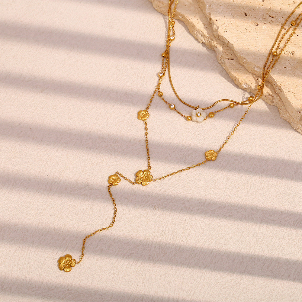 delicate layered stainless steel necklace with a flower-tipped drop
