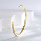 upright open bangle showing rows of clear zirconia at both tips