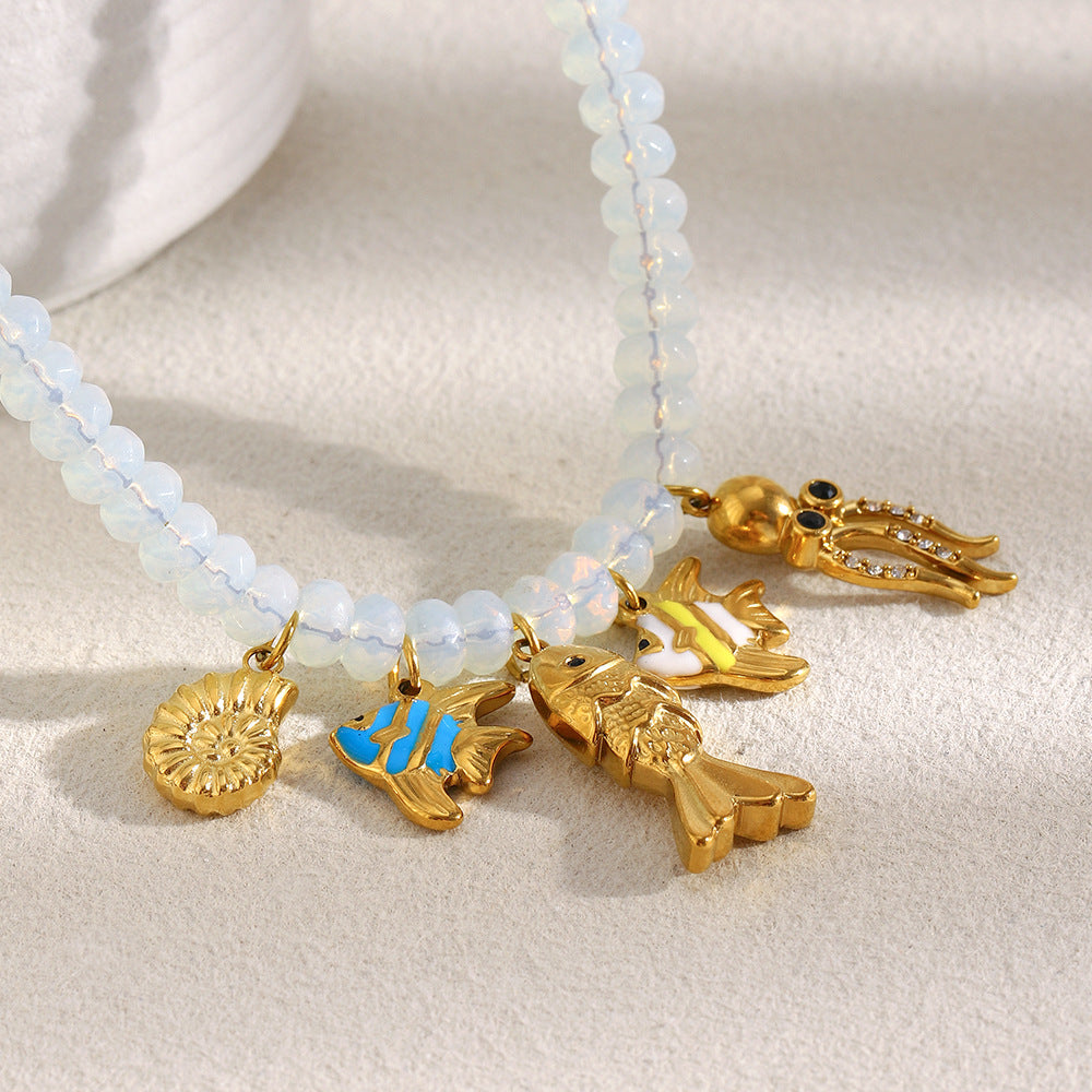 Close-up of pale beads and gold tone sea-life charms
