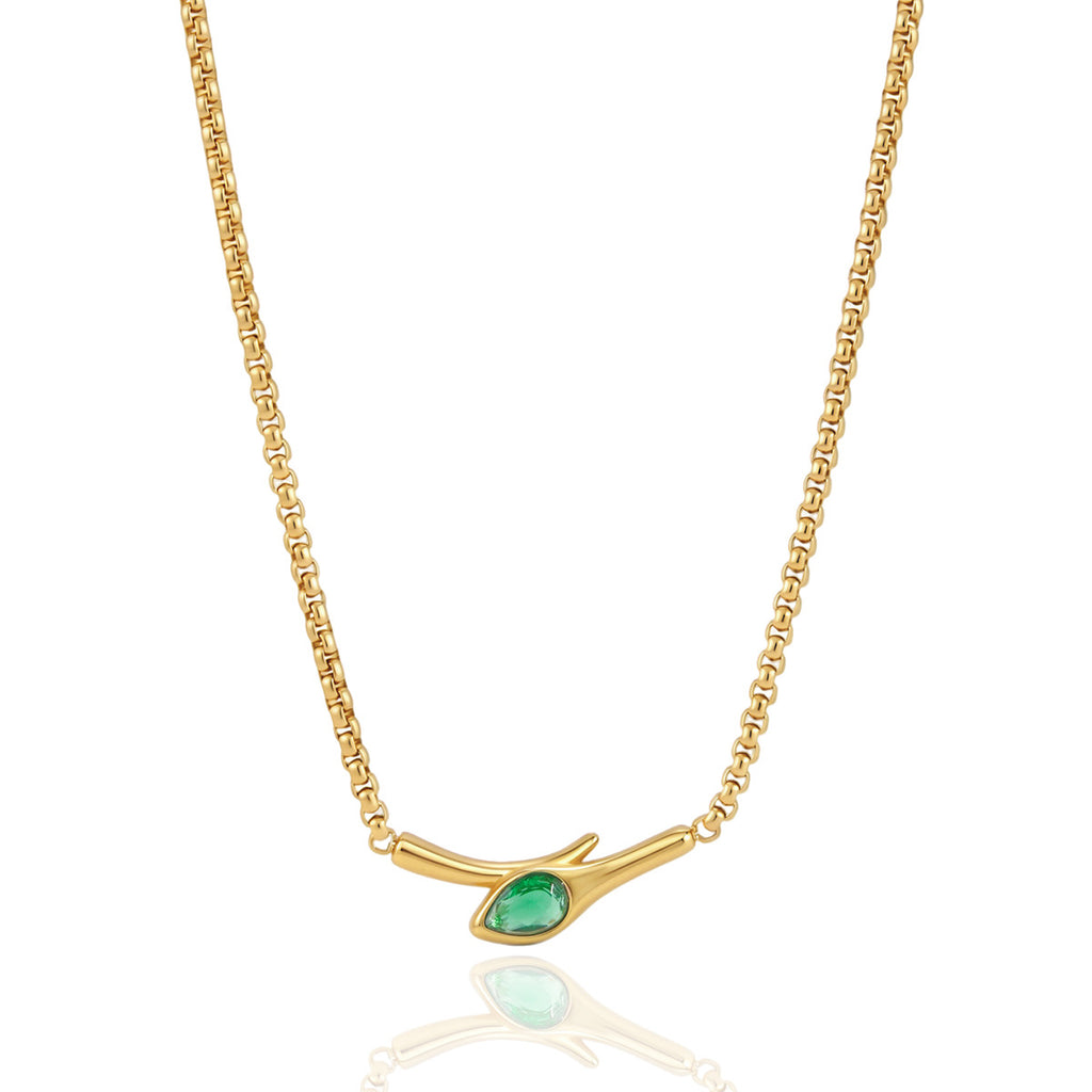 Front view of curved gold tone bar and green stone