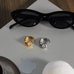 Open ring designs beside sunglasses