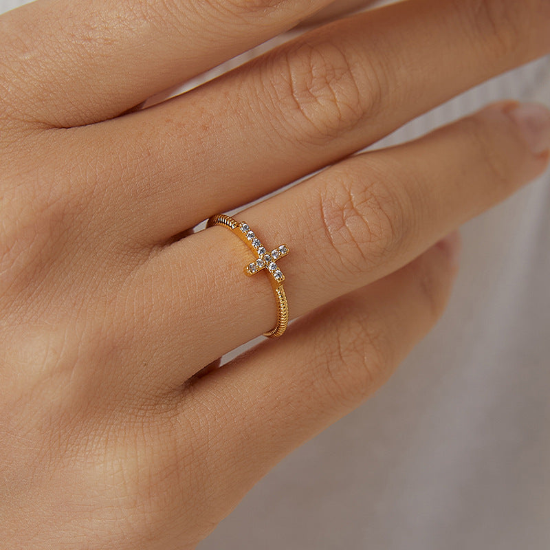 model hand wearing gold zirconia cross ring