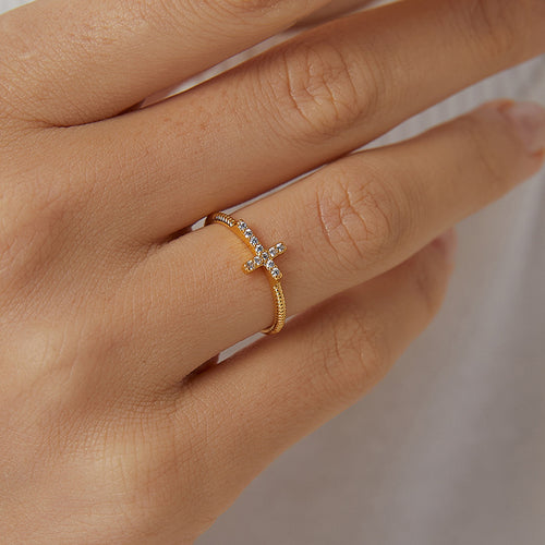 model hand wearing gold zirconia cross ring