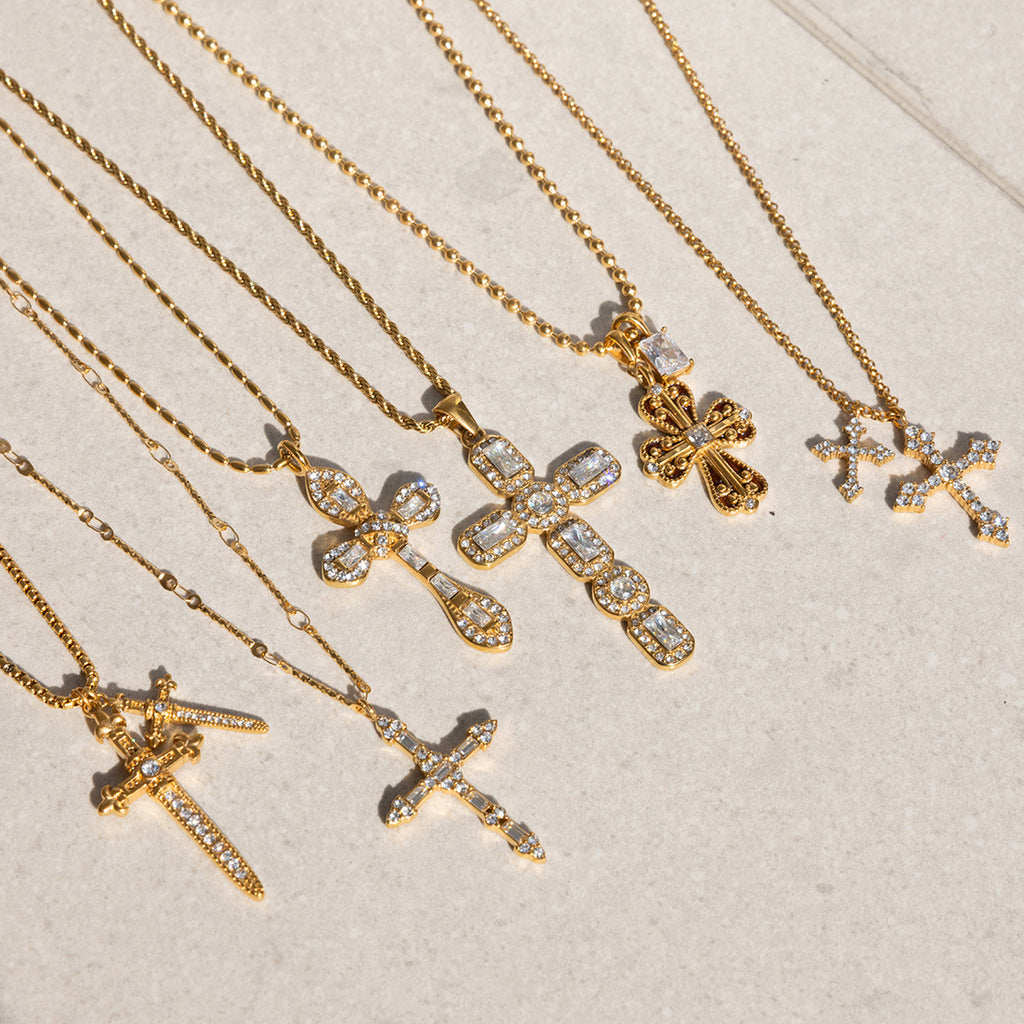 Gold-tone clear-accent cross necklaces arranged together