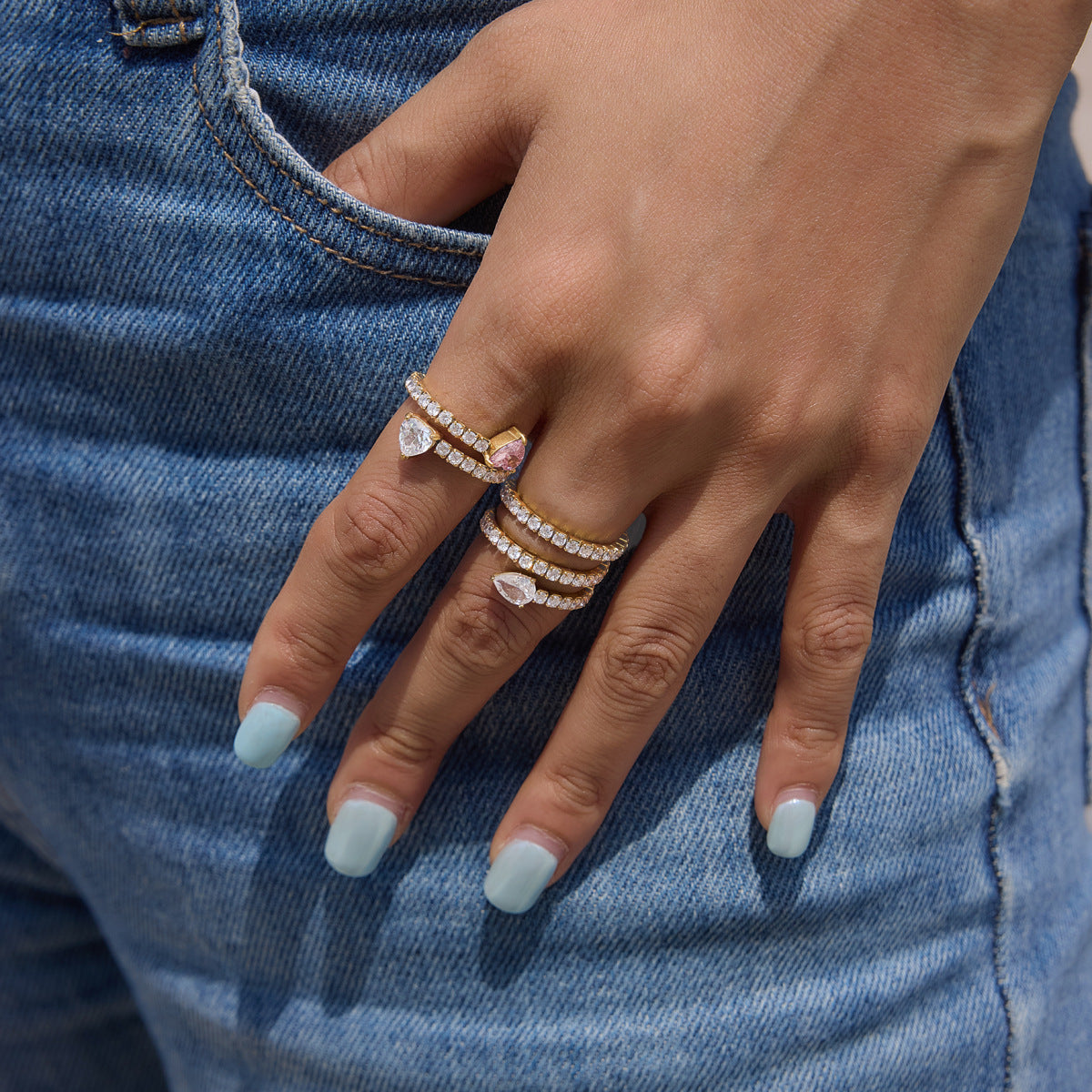 Stone-set spiral rings shown on a hand
