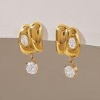 Pair of sculpted stainless steel earrings with round clear drops