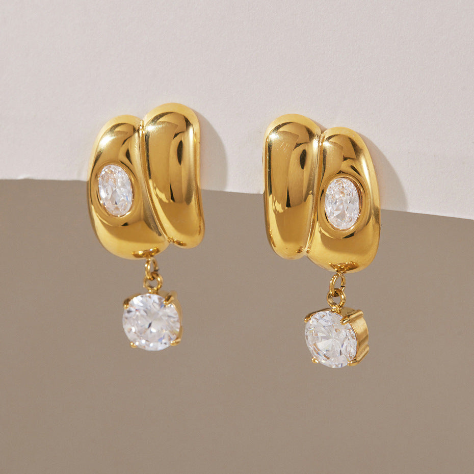 Pair of sculpted stainless steel earrings with round clear drops