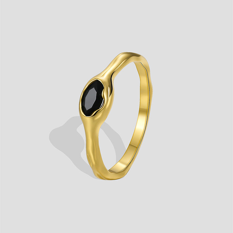 gold plated brass bezel ring with a faceted black stone