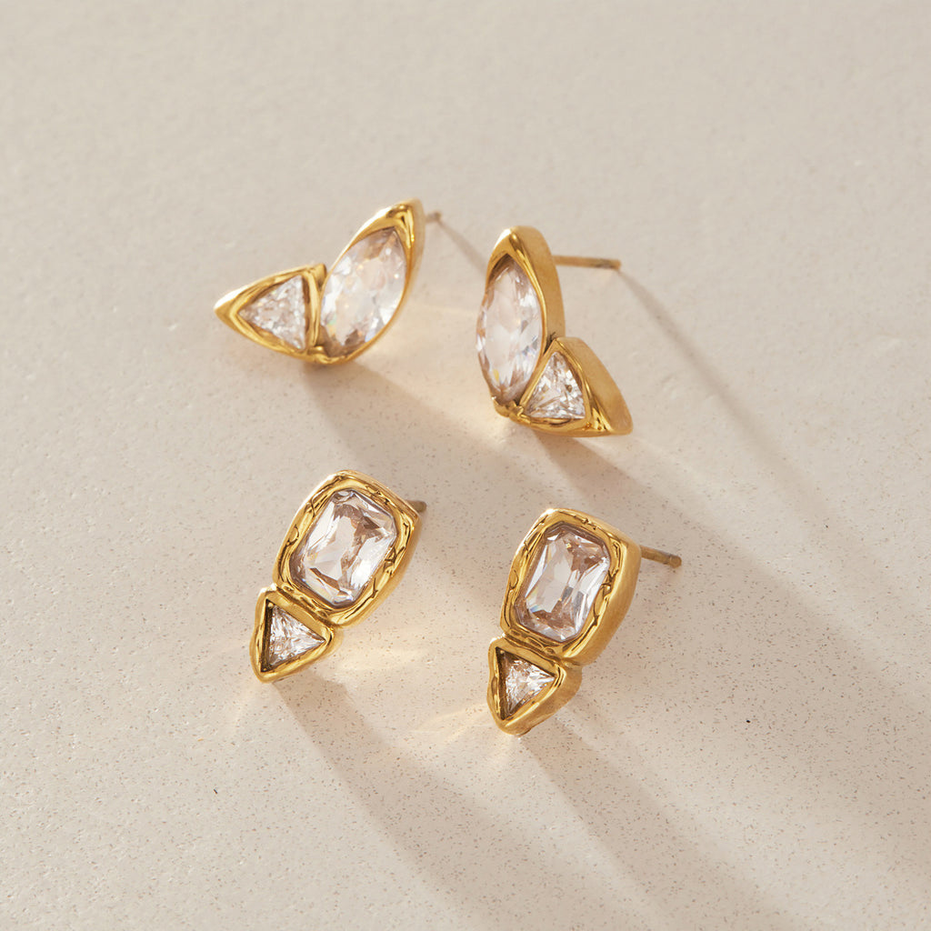 Marquise and rectangular two-stone studs on a textured surface