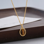 tiger's eye pendant necklace displayed against dark wood