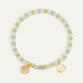 gold plated aqua and white bead bracelet with clear stone shell charm