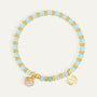 gold plated aqua and white bead bracelet with clear stone shell charm