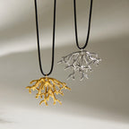 Both coral pendants hanging against a pale background